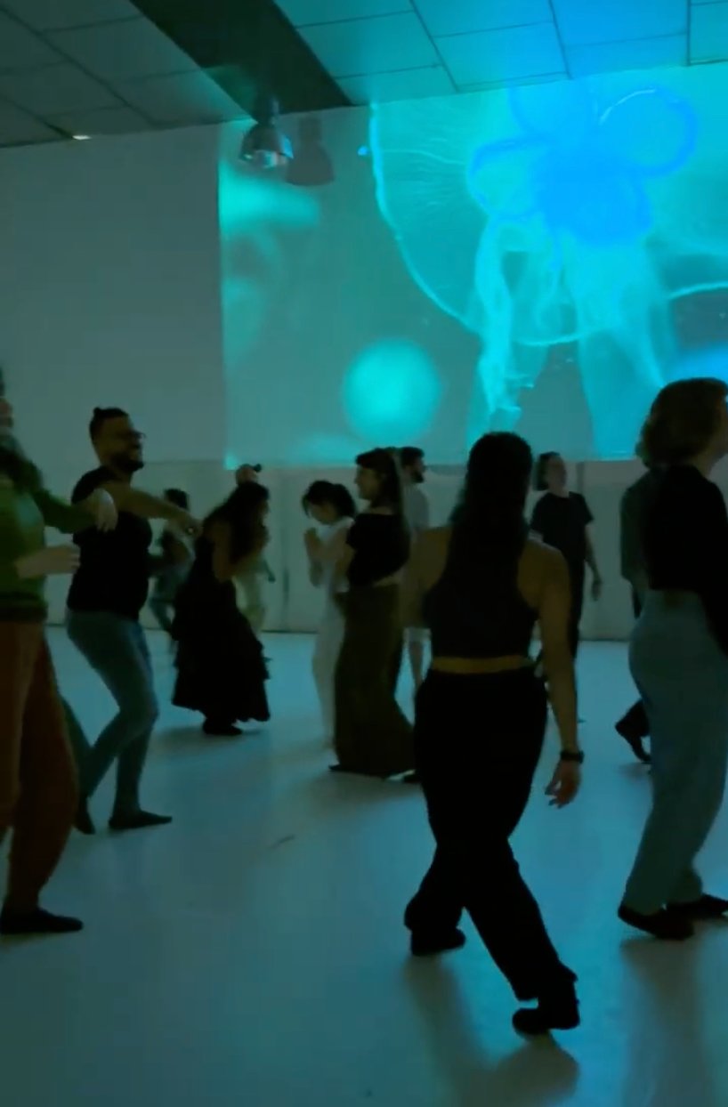 TinyParty dancers with blue jellyfish projection