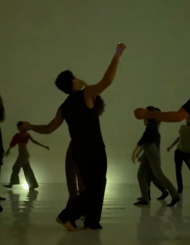 Dancer reaching up, green light