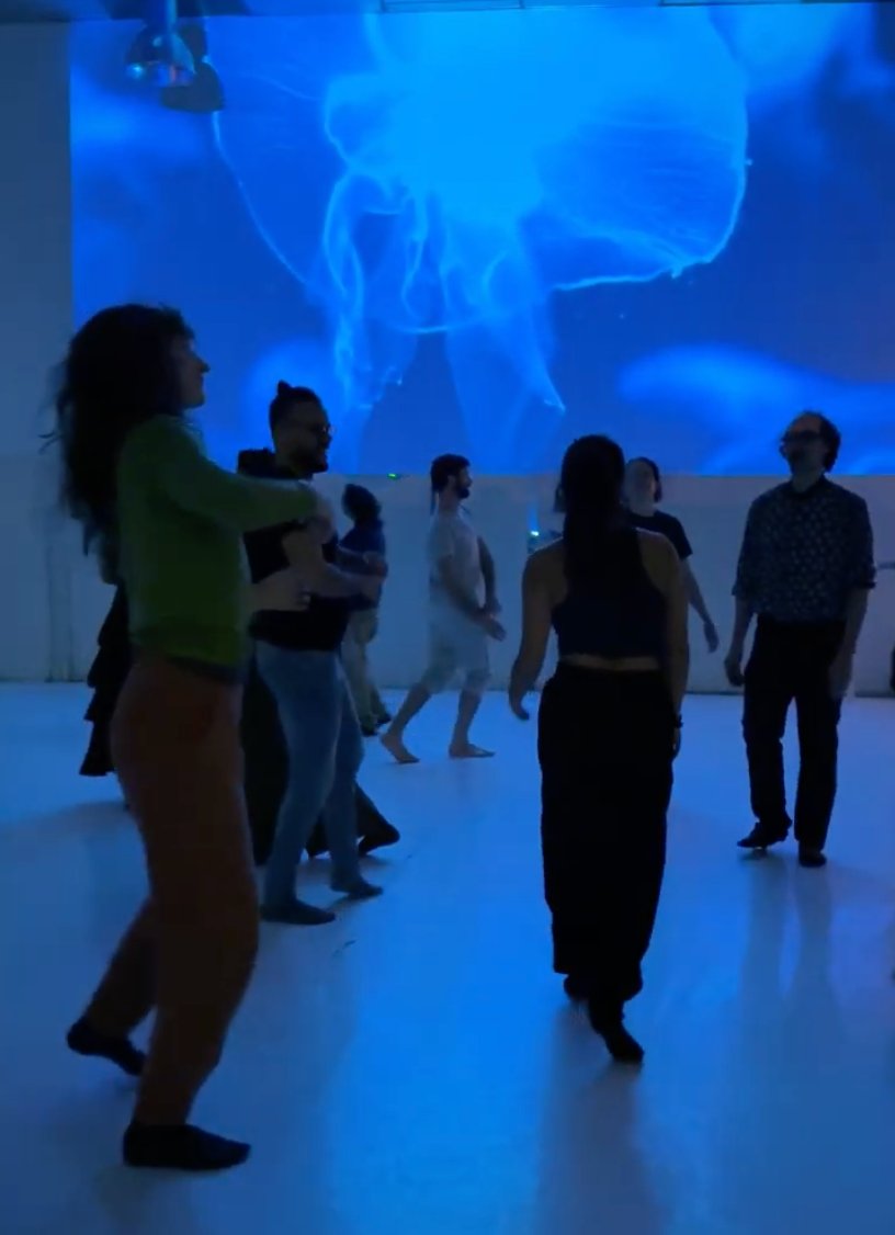 TinyParty dancers bathed in blue light